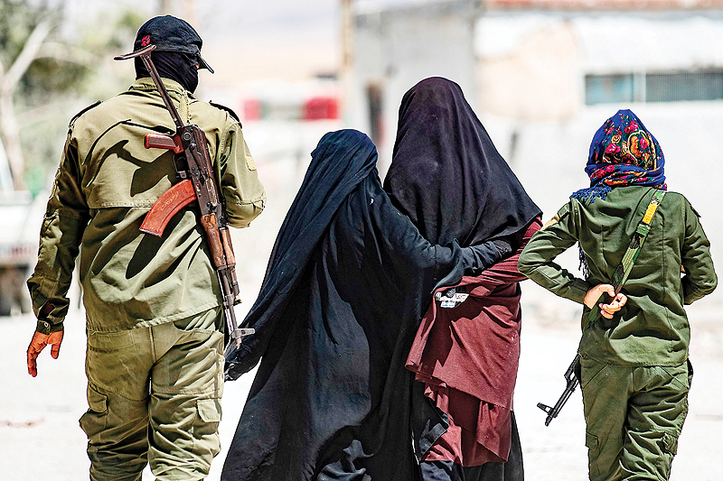  AL-HOL CAMP, Syria: An internal security patrol escorts women, reportedly wives of Islamic State group fighters, in this camp in Al-Hasakeh governorate in northeastern Syria on July 23, 2019. - AFP  