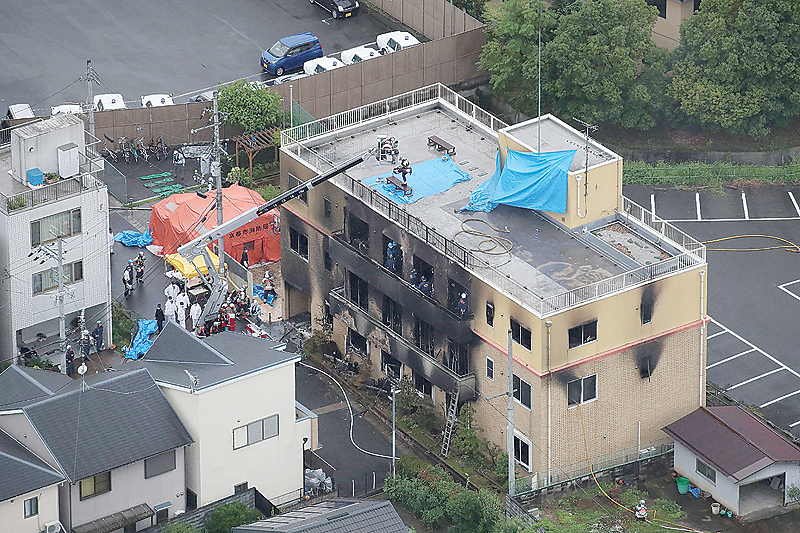 KYOTO: This aerial view shows the rescue and recover scene after a fire at an animation company building killed some two dozen people in Kyoto yesterday. —AFP