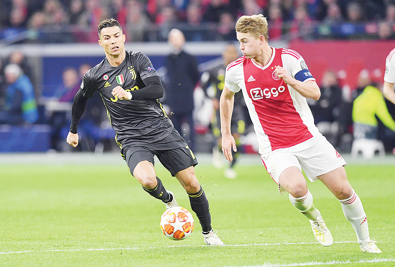 AMSTERDAM: In this file photo taken on April 10, 2019 Juventus’ Portuguese forward Cristiano Ronaldo (L) and Ajax’s Dutch defender Matthijs de Ligt run with the ball during the UEFA Champions League first leg quarter-final football match between Ajax Amsterdam and Juventus FC at the Johan Cruijff Arena. — AFP