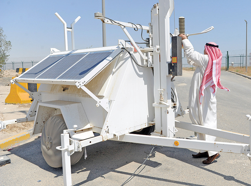 KUWAIT: A Kuwait Meteorological Center employee inspects a station as part of regular monitoring and maintenance to ensure the best weather data collection possible. — KUNA