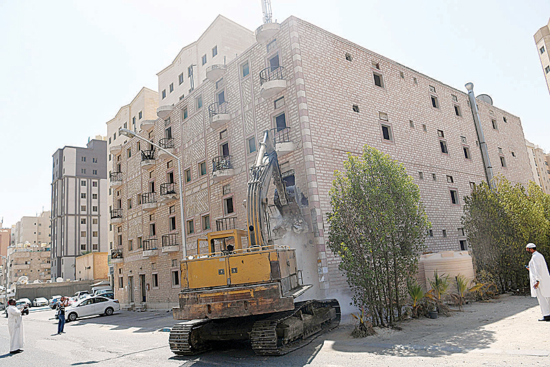KUWAIT: A bulldozer is seen removing violations in the building. —Photo by Yasser Al-Zayyat