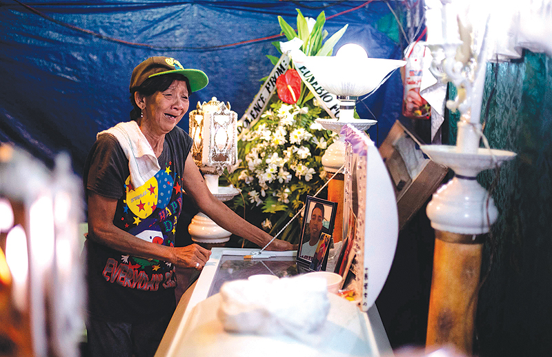 MANILA: This photo shows Lilia Jacobe, the grandmother of Bryan Conje, crying at his wake, who went missing on July 2, but was found dead on July 5 under a bridge where he lived. — A