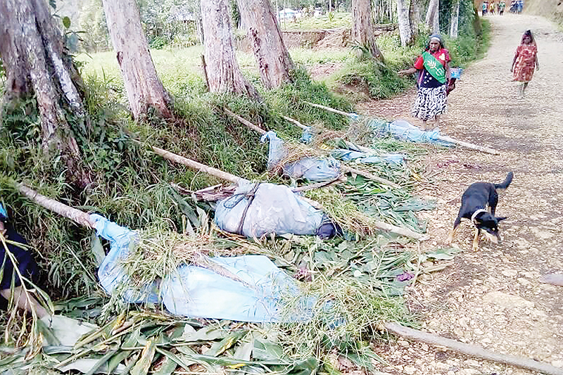 HELA: This handout photo obtained from the Department Of Health, Hela Province in Papua New Guinea shows dead bodies lined up on a road in Hela province. — AFP