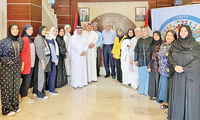 RAMALLAH: Members of the Kuwaiti delegation pose for a group picture with the hired Palestinian teachers. — KUNA photos