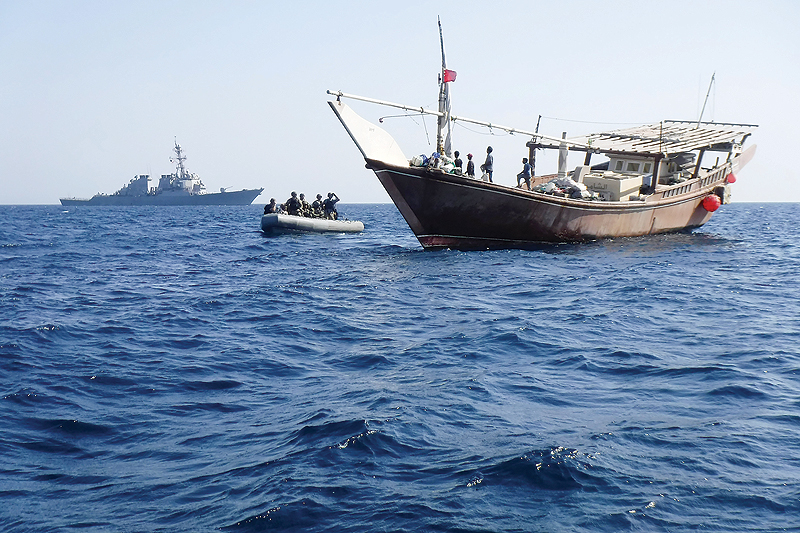 This handout picture released by the US Navy on June 25, 2019 shows a visit, board, search and seizure team from the Arleigh Burke-class guided-missile destroyer USS McFaul pulling alongside a Bahraini dhow during routine maritime security operations in the Gulf waters. - AFP  