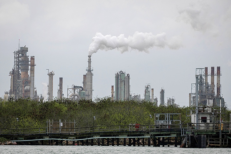 (FILES) In this file photo taken on March 11, 2019, an oil refinery near the Corpus Christi, Texas, Ship Channel. - The US economy grew slightly more slowly in the second quarter than previously thought, the government reported on August 29, 2019, with new data showing weaker oil exports and local government spending. GDP expanded in the April-June period by 2 percent, down a notch from the initial 2.1 percent growth estimate and well below President Donald Trump's three percent target, according to the Commerce Department. (Photo by Loren ELLIOTT / AFP)