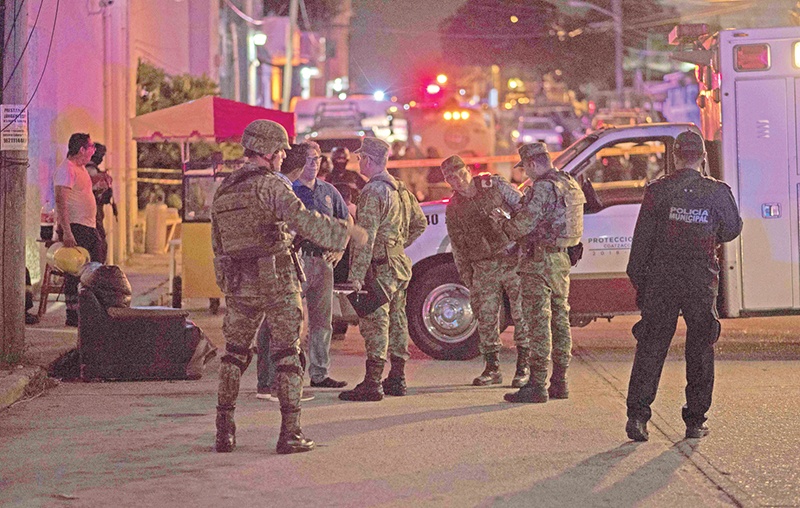 Mexican soldiers stand guard outside a bar where 23 people were killed by a fire in Coatzacoalcos, Veracruz on August 28, 2019. - At least 23 people were killed and 13 badly wounded in a fire at Caballo Blanco bar (White Horse bar) in eastern Mexico that is being investigated as an attack according to Mexiccan authorities. (Photo by ANGEL HERNANDEZ / AFP)