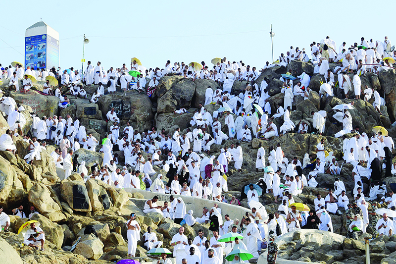 Muslim pilgrims pray at Mount Arafat, also known as Jabal al-Rahma (Mount of Mercy), southeast of the Saudi holy city of Mecca, as the climax of the Hajj pilgrimage approaches on August 10, 2019. - Arafat is the site where Muslims believe the Prophet Mohammed gave his last sermon about 14 centuries ago after leading his followers on the pilgrimage. The ultra-conservative kingdom, which is undergoing dramatic social and economic reforms, has mobilised vast resources for the six-day journey, one of the five pillars of Islam. (Photo by FETHI BELAID / AFP)