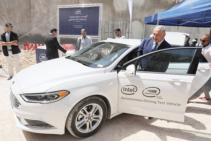 Israeli Prime Minister Benjamin Netanyahu boards an autonomous vehicle during a cornerstone ceremony for the Mobileye campus in Har Hahotzvim northwest of Jerusalem on August 27, 2019. (Photo by ABIR SULTAN / POOL / AFP)