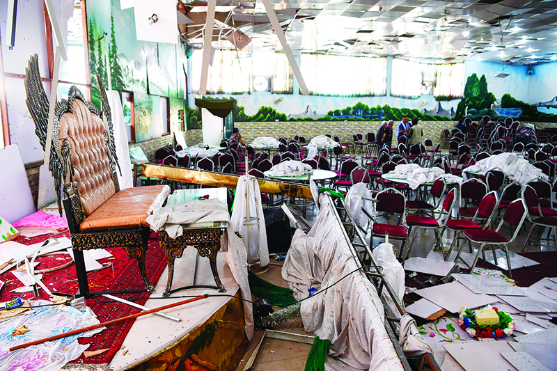 TOPSHOT - Afghan men investigate in a wedding hall after a deadly bomb blast in Kabul on August 18, 2019. - More than 60 people were killed and scores wounded in an explosion targeting a wedding in the Afghan capital, authorities said on August 18, the deadliest attack in Kabul in recent months. (Photo by Wakil KOHSAR / AFP)