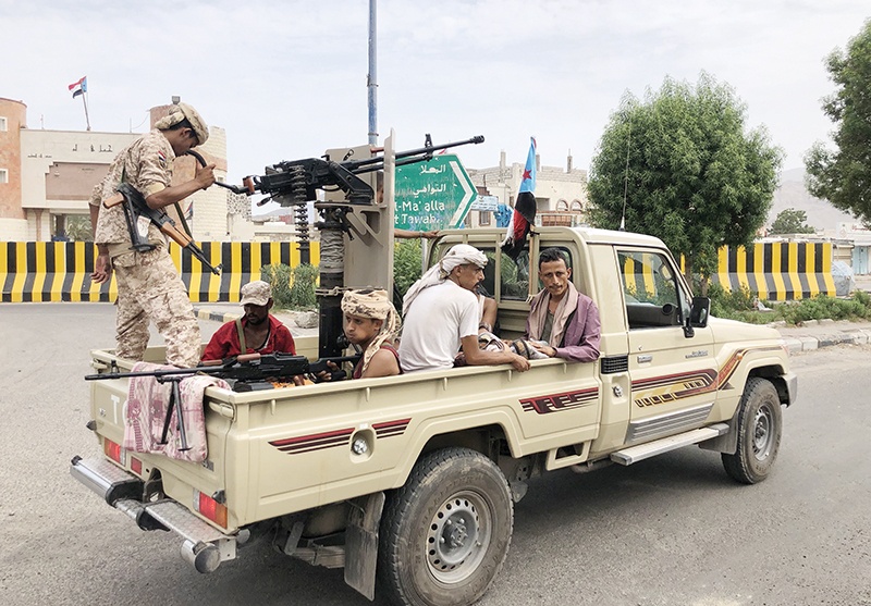 Fighters of the UAE-trained Security Belt Force, dominated by members of the Southern Transitional Council (STC) which seeks independence for south Yemen, patrol a street in an area near the Aden International airport on August 28, 2019. (Photo by Nabil HASAN / AFP)