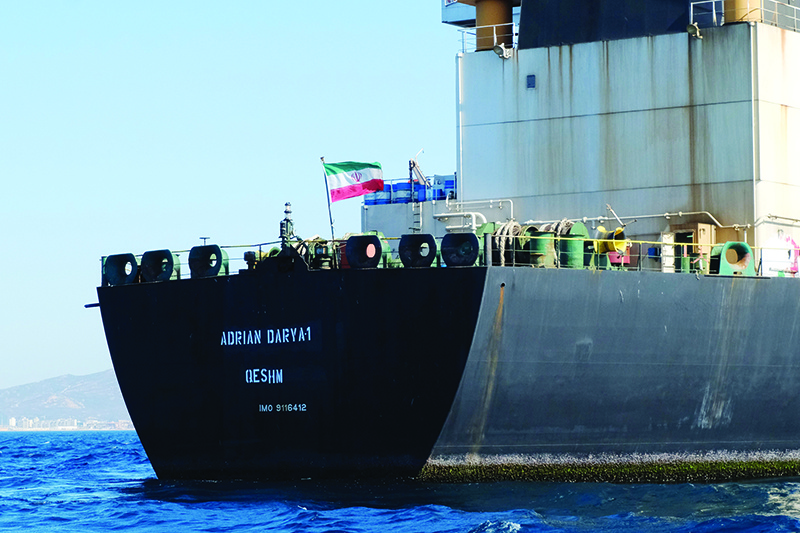 TOPSHOT - An Iranian flag flutters on board the Adrian Darya oil tanker, formerly known as Grace 1, off the coast of Gibraltar on August 18, 2019. - Gibraltar rejected a US demand to seize the Iranian oil tanker at the centre of a diplomatic dispute as it prepared to leave the British overseas territory after weeks of detention. (Photo by Johnny BUGEJA / AFP)