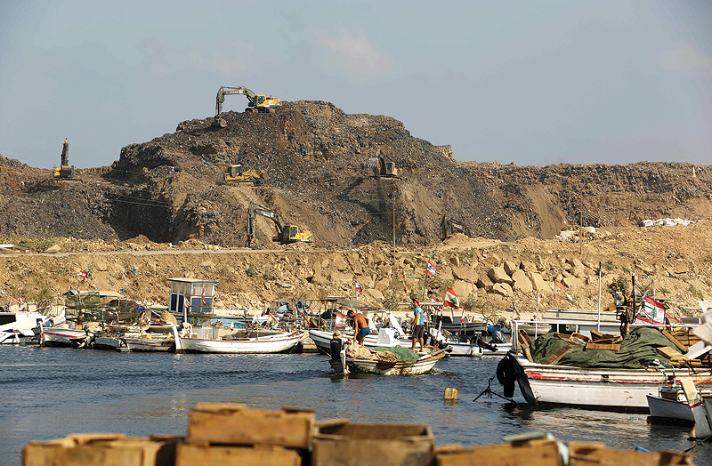 BEIRUT: This file photo taken on Aug 16, 2017 shows a general view of the Bourj Hammoud fishing port, in front of a large landfill dump (background). - AFP 