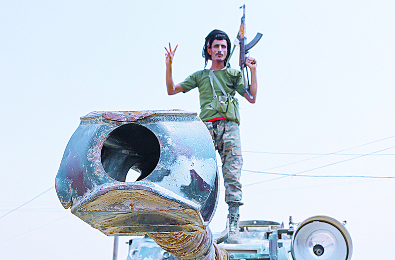 A fighter with the UAE-trained Security Belt Forces loyal to the pro-independence Southern Transitional Council (STC), stands atop a military vehicle near the south-central coastal city of Zinjibar in south-central Yemen, in the Abyan Governorate, on August 21, 2019. - Yemeni separatists drove government troops out of two military camps in deadly clashes yesterday, reinforcing their presence in the south after they seized the de facto capital Aden. (Photo by Nabil HASAN / AFP)
