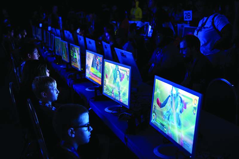 Competitors play a video game during the first day of the 2019 Pokemon World Championships at the Washington Convention Center August 16, 2019, in Washington, DC. (Photo by Brendan Smialowski / AFP)