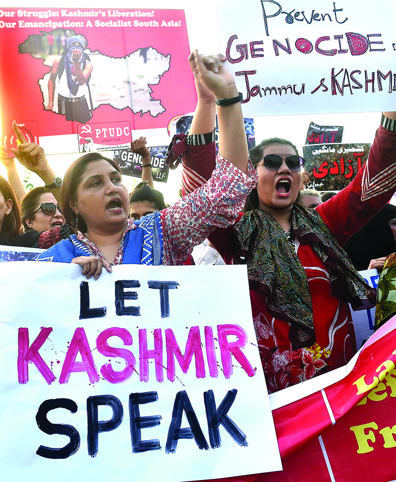 Pakistani civil society activists carry placards as they shout slogans during a protest rally in Lahore on August 20, 2019, as they condemn the India stripped the disputed Kashmir region of its special autonomy and imposed a lockdown two weeks ago. - US President Donald Trump on August 19 spoke with India's Prime Minister Narendra Modi, urging a reduction of tension between India and Pakistan over the disputed Kashmir region. (Photo by ARIF ALI / AFP)