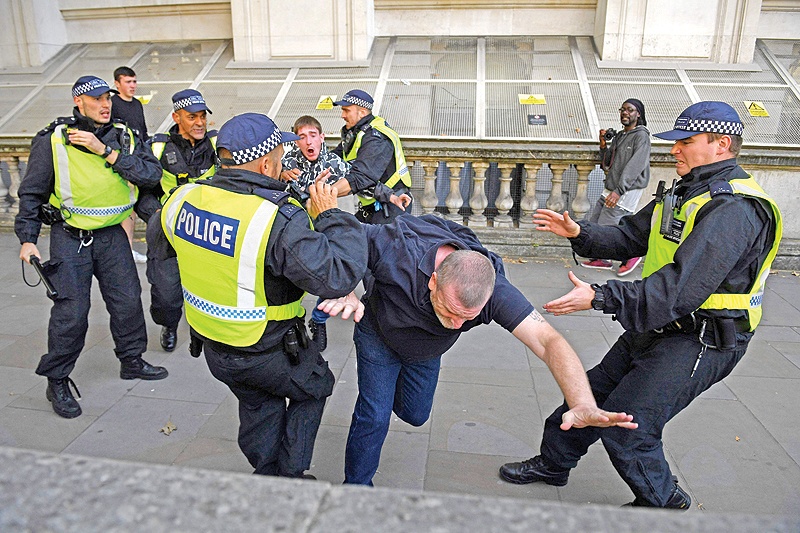 LONDON: Police officers remonstrate with demonstrators on Parliament Square, during an anti-government protest calling for the Prime Minister’s resignation, near Whitehall and Downing Street. — AFP