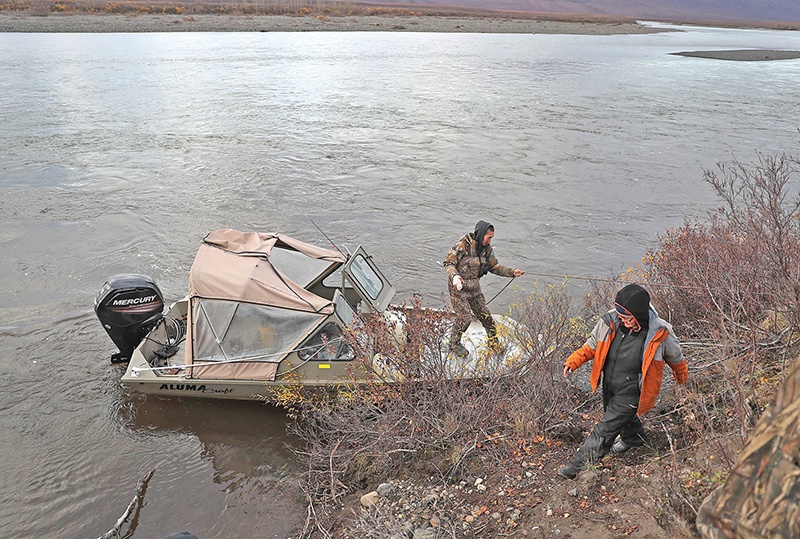 KIVALINA, ALASKA - SEPTEMBER 11: Tommy Swan (L) and Rhonda Norton take to the bank of a river as they hunt for caribou along the Wulik river on September 11, 2019 in Kivalina, Alaska. The hunters in the village have seen the migration patterns of fish, caribou, seal and whale that they need for the long winter months change due to the warming weather. Kivalina is situated at the very end of an eight-mile barrier reef located between a lagoon and the Chukchi Sea. The village is 83 miles above the Arctic circle. Kivalina and a few other native coastal Alaskan villages face the warming of the Arctic, which has resulted in the loss of sea ice that buffers the islands shorelines from storm surges and coastal erosion. The residents of Kivalina are hoping to stay on their ancestral lands where they can preserve their culture, rather than dispersing due to their island being swallowed by the rising waters of the ocean. City Administrator Colleen Swan says that the way of life in the village will change with the changing climate and they will adapt. In days gone by, they could migrate with the changes. But now, she says, with the magnitude of problem climate change brings, they must hope that the rest of the world reverses the trend, which she sees as being man-made, and save their way of life.   Joe Raedle/Getty Images/AFPn== FOR NEWSPAPERS, INTERNET, TELCOS &amp; TELEVISION USE ONLY ==