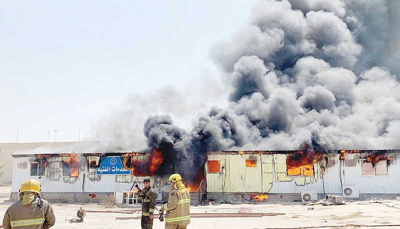KUWAIT: Smoke billows out of a fire in makeshift homes used in the Sheikh Sabah Al-Ahmad Olympic Shooting Complex.