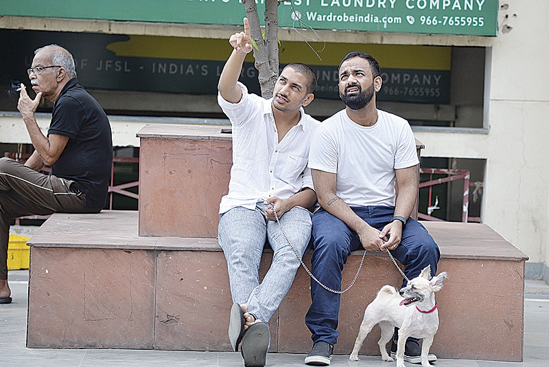 GURGAON, India:  In this photograph Indian gay married couple Vishwa Srivastava, right, and Vivek Kishore, left, sit on a bench at a market in Gurgaon on the outskirts of New Delhi.-AFP