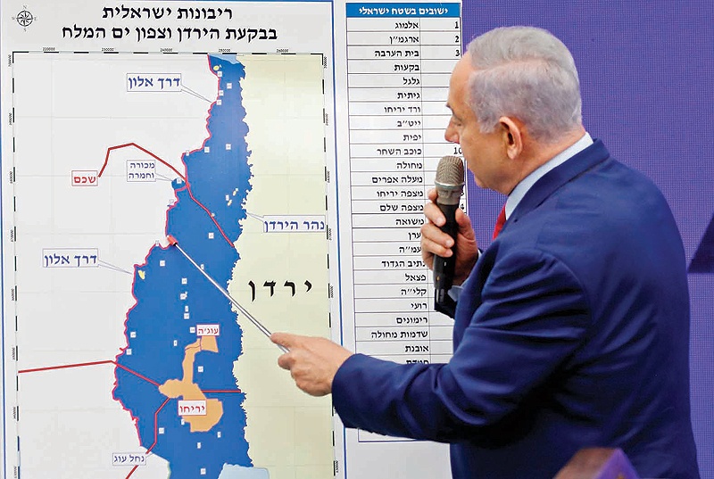 RAMAT GAN: Israeli Prime Minister Benjamin Netanyahu points at a map of the Jordan Valley as he gives a statement near Tel Aviv yesterday. - AFP 