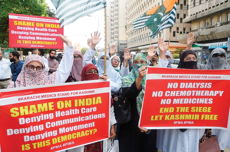 KARACHI: Pakistani doctors hold placards and shout slogans as they take part in a protest against India, in Karachi. — AFP