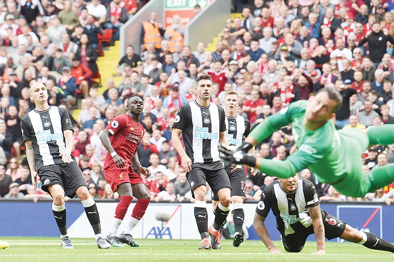 LIVERPOOL: Liverpool's Senegalese striker Sadio Mane (2L) scores the team's first goal during the English Premier League football match between Liverpool and Newcastle at Anfield in Liverpool, north west England yesterday. - AFP