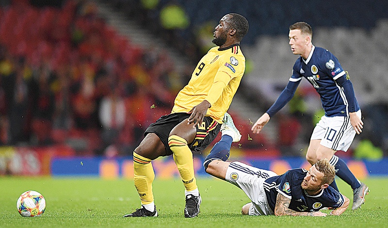 GLASGOW: Belgium's striker Romelu Lukaku (L) is tackled by Scotland's defender Liam Cooper (C) during the Euro 2020 football qualification match between Scotland and Belgium at Hampden Park, Glasgow. - AFP 