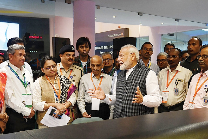 BANGALORE: Indian Prime Minister Narendra Modi (centre right) speaks with Indian Space Research Organization (ISRO) scientists at the ISRO headquarters in Bangalore. - AFP 