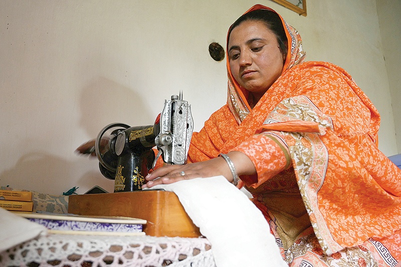 BOONI, Pakistan: In this picture Pakistani woman Hajra Bibi makes a sanitary pad with a sewing machine at her home in Booni village in Chitral. — AFP