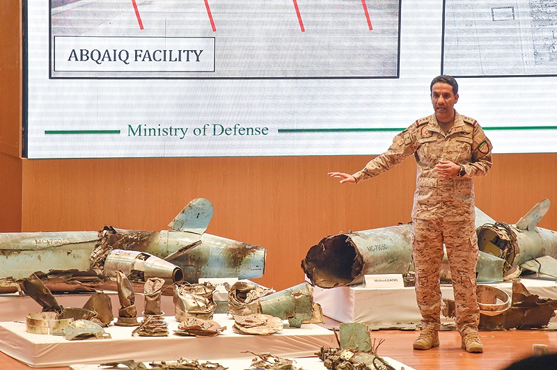 RIYADH: Saudi defense ministry spokesman Colonel Turki bin Saleh Al-Malki displays pieces of what he said are Iranian cruise missiles and drones recovered from the attack site that targeted Saudi Aramco's facilities during a press conference yesterday. - AFP