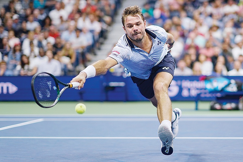 NEW YORK: Stan Wawrinka of Switzerland reaches for the ball from Novak Djokovic of Serbia in their Round Four Men’s Singles tennis match during the 2019 US Open at the USTA Billie Jean King National Tennis Center in New York. —AFP