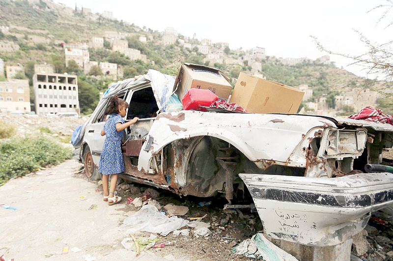TAEZ: A Yemeni child buys sweets from Majd Al-Din Al-Shamiri (unseen), a 16 year-old Yemeni who set up a shop in his family’s car that was destroyed during the ongoing war in the Jabal Sabr area of the southwestern city of Taez. —AFP