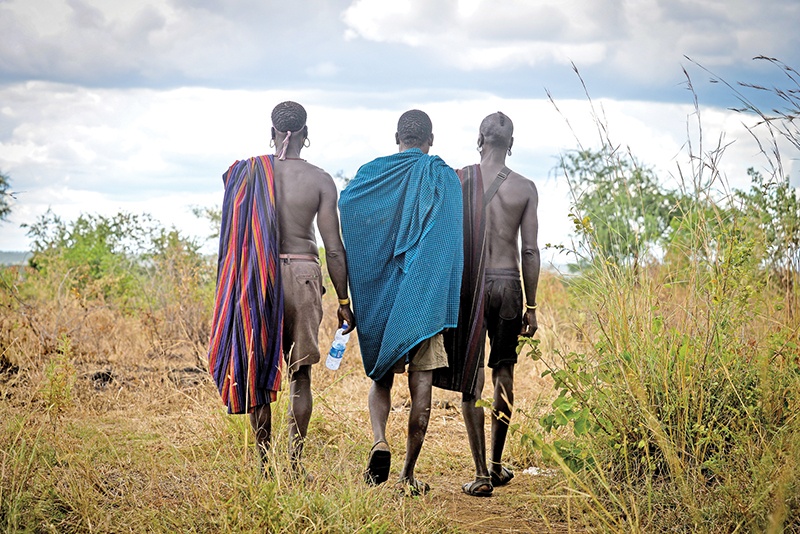 Members of the Mursi tribe, an agro-pastoralist tribe in southwestern Ethiopia are seen on October 4, 2019 in the Lower Omo Valley. - For decades, Ethiopian pastoralists in the Lower Omo Valley have relied on firearms to fend off rivals as well as hyenas and lions roaming the region's forests and plains. nBut over the past month, security forces have embarked on an aggressive disarmament campaign that local communities say has been accompanied by indiscriminate shooting of civilians, mass detentions and beatings. (Photo by MICHAEL TEWELDE / AFP)