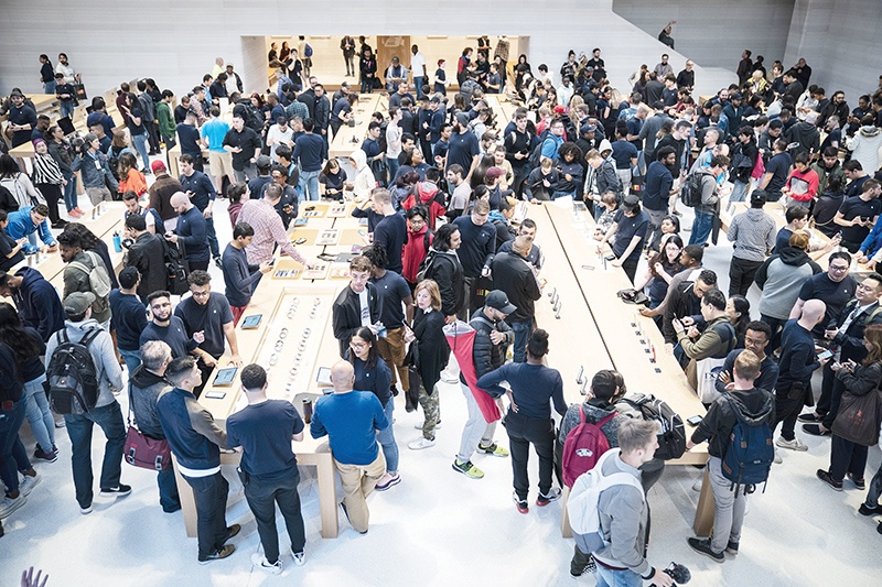 (FILES) In this file photo taken on September 20, customers shop at Apple's flagship 5th Avenue store in New York City. - American consumers tightened their purse strings unexpectedly last month, breaking a seven-month winning streak, government data showed on October 16, 2019. Shoppers took home fewer autos and spent less on gasoline, groceries and building supplies while buying less online as well, according to the Commerce Department. (Photo by Drew Angerer / GETTY IMAGES NORTH AMERICA / AFP)