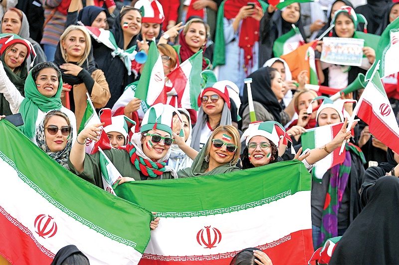 TEHRAN: Iranian women cheer during the World Cup Qatar 2022 Group C qualification football match between Iran and Cambodia at the Azadi stadium in the capital Tehran yesterday. — AFP