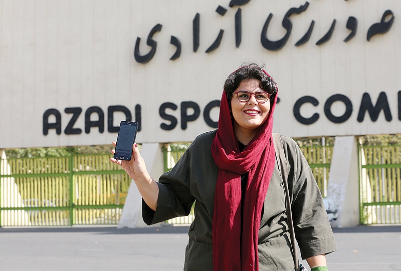 TEHRAN: Iranian sports journalist Raha Pourbakhsh shows purchased electronic tickets for the Iran-Cambodia World Cup 2022 qualifier match during an interview with in front of Azadi stadium on Tuesday. - AFP 