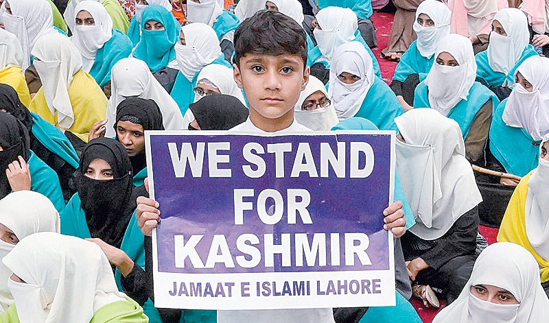 LAHORE: A boy shows a placard supporting Kashmir as supporters and activists of Jamaat-e-Islami Pakistan walk during a Kashmir Azadi (‘Freedom for Kashmir’) march in Lahore. —AFP