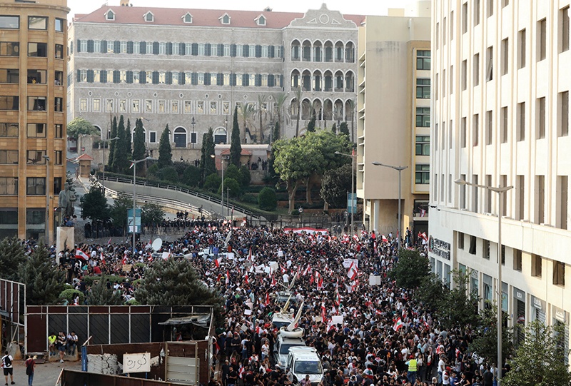 Lebanese protesters rally in downtown Beirut as hundreds continue to gather for a third day of demonstrations against tax increases and official corruption, on October 19, 2019. - Thousands of protesters outraged by corruption and proposed tax hikes burned tyres and blocked major highways in Lebanon on Friday, prompting the premier to give his government partners three days to support a reform drive. (Photo by ANWAR AMRO / AFP)