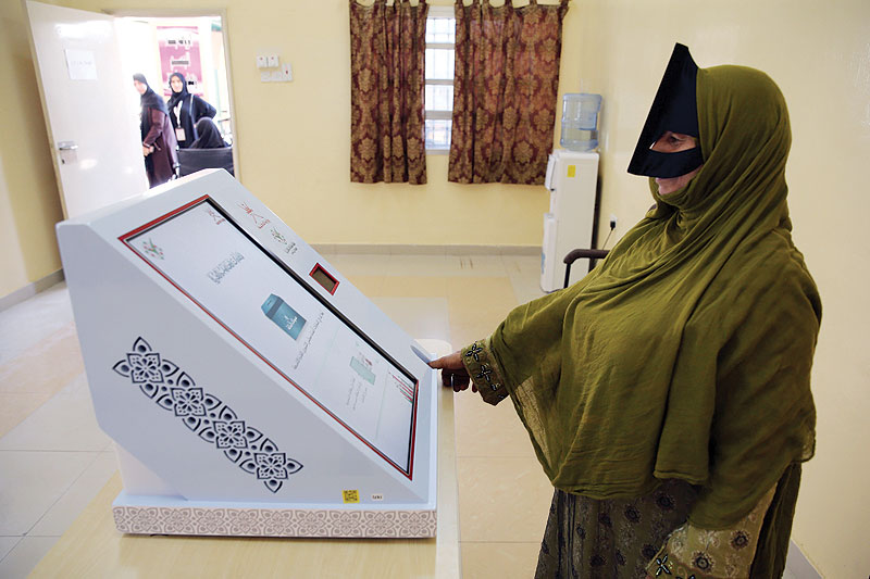 IZKI, Oman: An Omani woman casts her ballot at a polling station in this northeastern town during consultative council elections yesterday. - AFP 