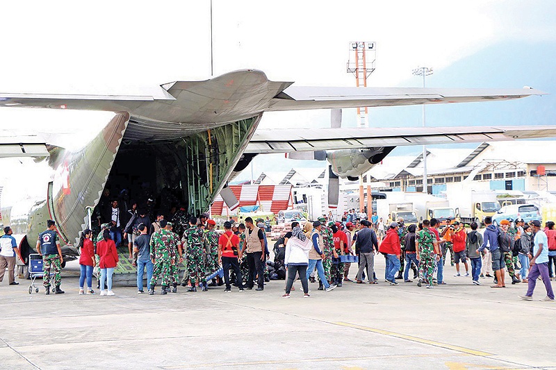 WAMENA: Indonesian military assist residents evacuated from Jayapura after they arrived at an airport in Wamena. Anger over racism against indigenous Papuans by residents from other parts of Indonesia has fuelled weeks of angry protests in the impoverished region. — AFP