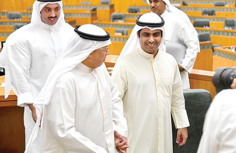 KUWAIT: Interior Minister Sheikh Khaled Al-Jarrah Al-Sabah and MP Riyadh Al-Adasani, who grilled him in parliament, walk hand-in-hand after the session at the National Assembly late Tuesday. — Photo by Yasser Al-Zayyat