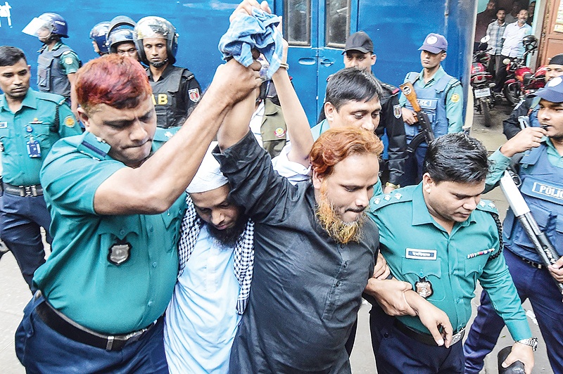 DHAKA: Police escort extremists accused of allegedly plotting the Holey Artisan Bakery cafe attack to a courtroom for their trial yesterday. — AFP