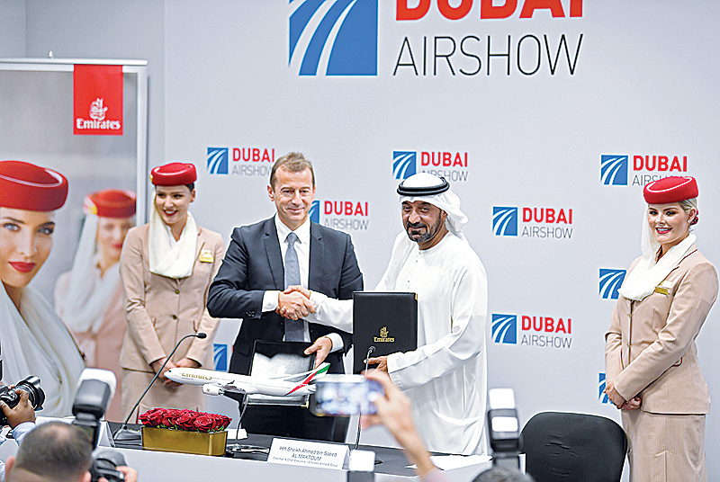 DUBAI: Ahmed bin Saeed Al Maktoum, CEO and chairman of the Emirates Group, and Guillaume Faury, Airbus CEO, pose for a picture after the signing of an agreement during the Dubai Airshow yesterday. —AFP