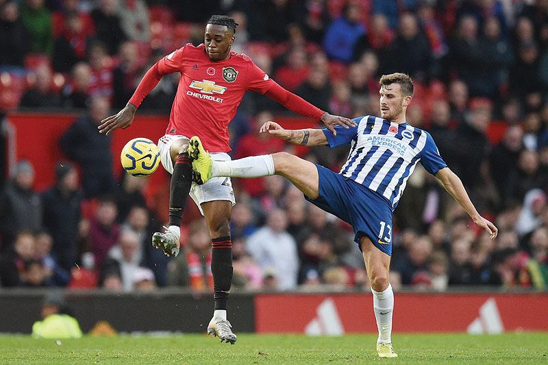 OLD TRAFFOED: Brighton's German midfielder Pascal Gross (R) challenges Manchester United's defender Aaron Wan-Bissaka (L) during the English Premier League football match between Manchester United and Brighton and Hove Albion at Old Trafford in Manchester, north west England yesterday. - AFP