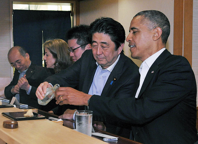 This file handout photo taken and released by Japan's Cabinet Public Relations Office shows Japan's Prime Minister Shinzo Abe, 2nd right, and US President Barack Obama, right, at the Sukiyabashi Jiro restaurant in Tokyo.—AFP 