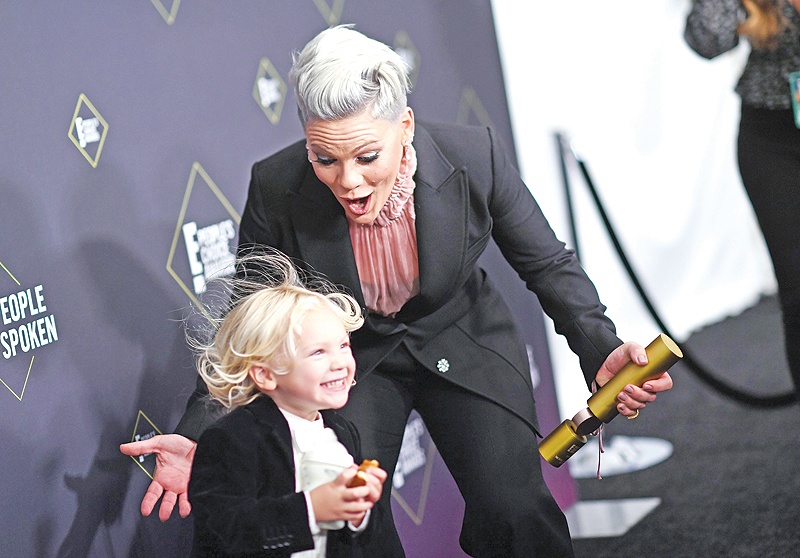 US singer/songwriter Pink reacts as her son Jameson Moon Hart runs towards her as she gets ready to pose with the People’s Champion Award during the 45th annual E! People’s Choice Awards at Barker Hangar in Santa Monica, California. — AFP