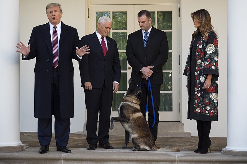 (FILES) In this file photo taken on November 24, 2019 US President Donald Trump (L), Vice President Mike Pence (2nd L) and First Lady Melania Trump (R) stand with Conan, the military dog that was involved with the death of ISIS leader Abu Bakr al-Baghdadi, at the White House in Washington, DC. - President Donald Trump has shattered norms and niceties on the world stage in his nearly three years in office. Entering an election year, Trump is unlikely to slow down as he seeks what has largely eluded him -- a headline-grabbing victory. (Photo by JIM WATSON / AFP)