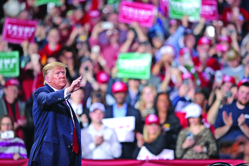 BATTLE CREEK, MICHIGAN - DECEMBER 18: President Donald Trump leaves his Merry Christmas Rally at the Kellogg Arena on December 18, 2019 in Battle Creek, Michigan. While Trump spoke at the rally the House of Representatives voted, mostly along party lines, to impeach the president for abuse of power and obstruction of Congress, making him just the third president in U.S. history to be impeached.   Scott Olson/Getty Images/AFP