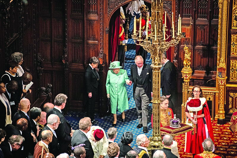 Britain's Queen Elizabeth II and her son Britain's Prince Charles, Prince of Wales arrive in the House of Lords chamber during the State Opening of Parliament in the Houses of Parliament in London on December 19, 2019. - The State Opening of Parliament is where Queen Elizabeth II performs her ceremonial duty of informing parliament about the government's agenda for the coming year in a Queen's Speech. (Photo by Leon Neal / POOL / AFP)